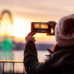 Person taking a picture of the Ferris wheel in Seattle, WA
