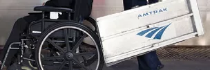 Amtrak employee assisting with wheelchair