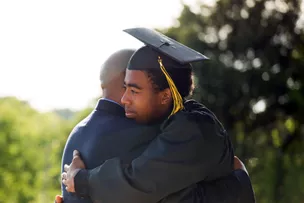Father and son hugging after graduation