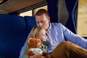 Man with daughter on train